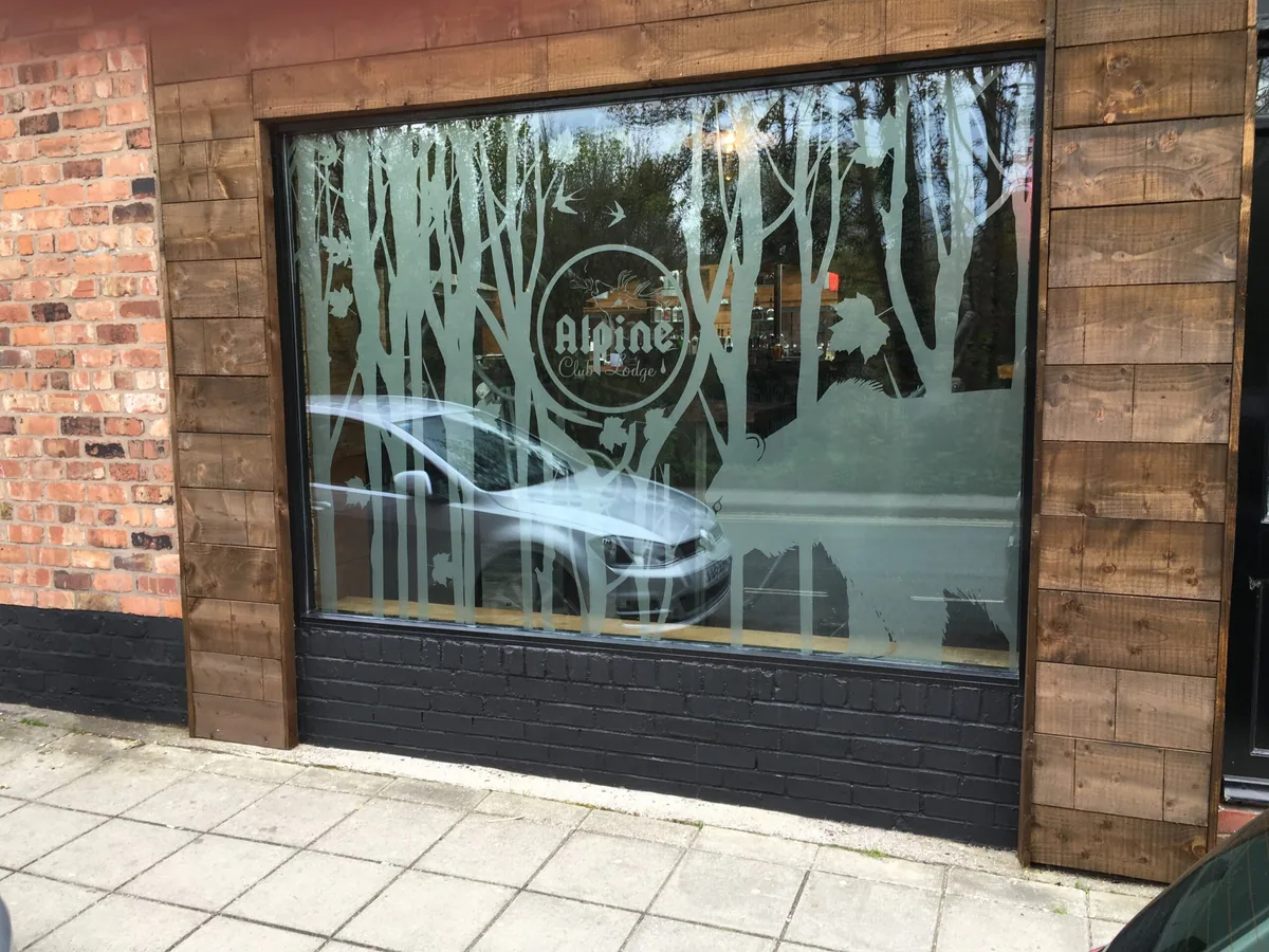 Frosted café logo and lettering on a shop window