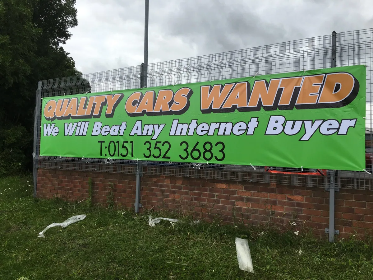 Green Houses Wanted advertising banner on a fence