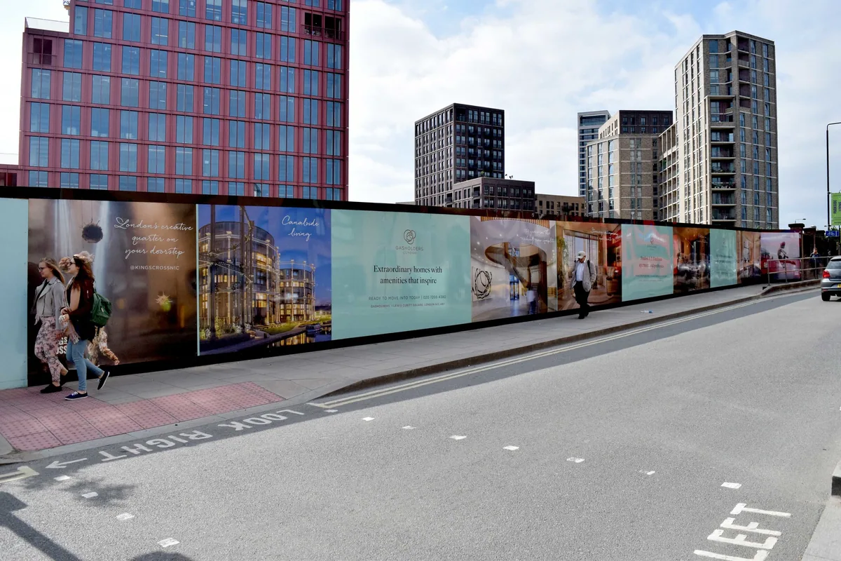 Printed construction site hoarding panels along a pavement