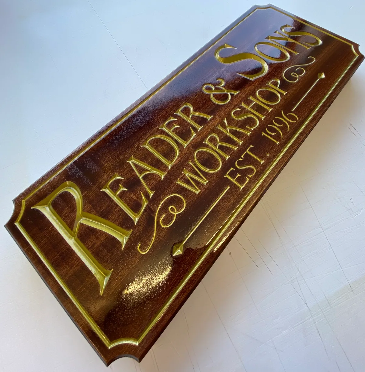 Engraved Iroko timber sign with gold-coloured infill
