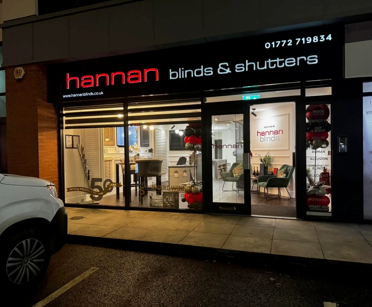 Hannan Blinds and Shutters illuminated red and white fascia at night