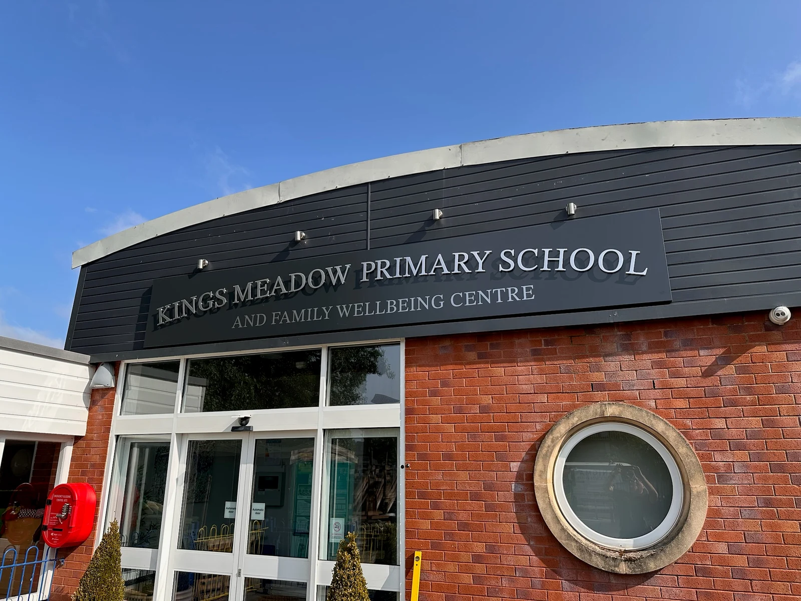 Angled view of the raised Kings Meadow lettering and dark fascia