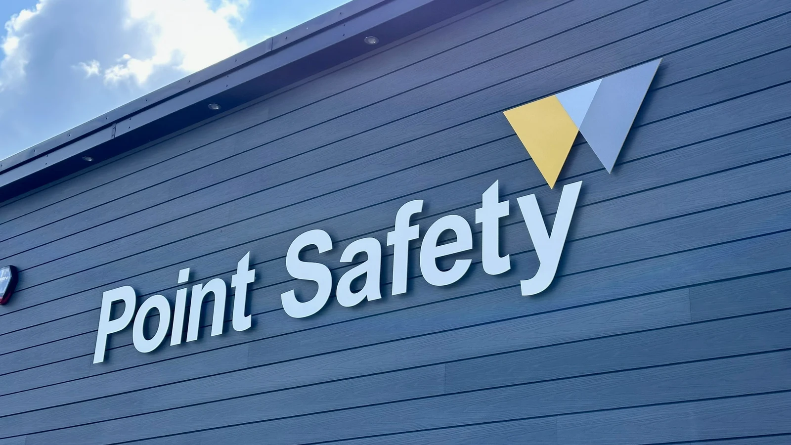 White Point Safety individual letters and coloured logo mounted on dark cladding