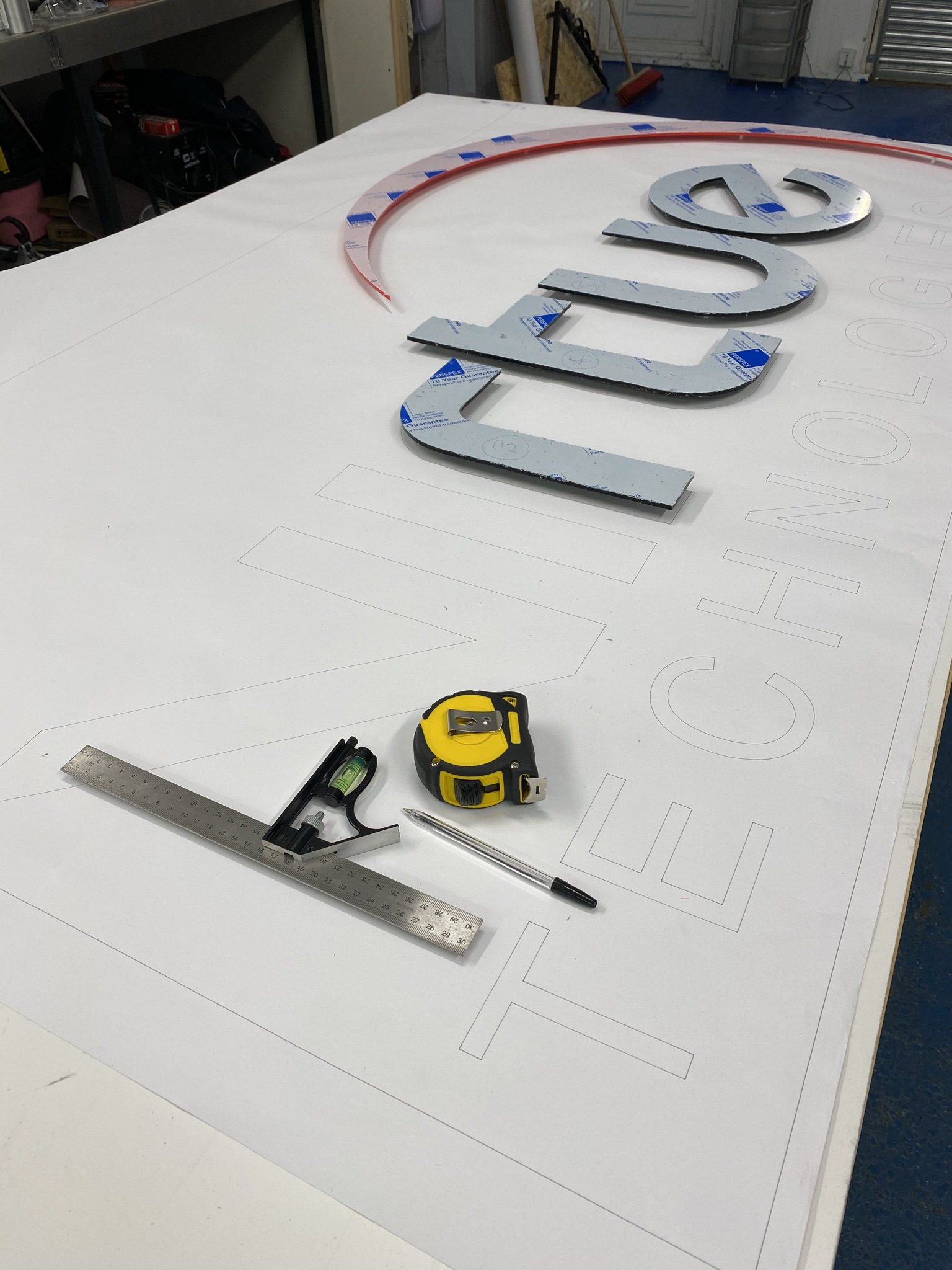 Cut letters and paper layout template on a work table