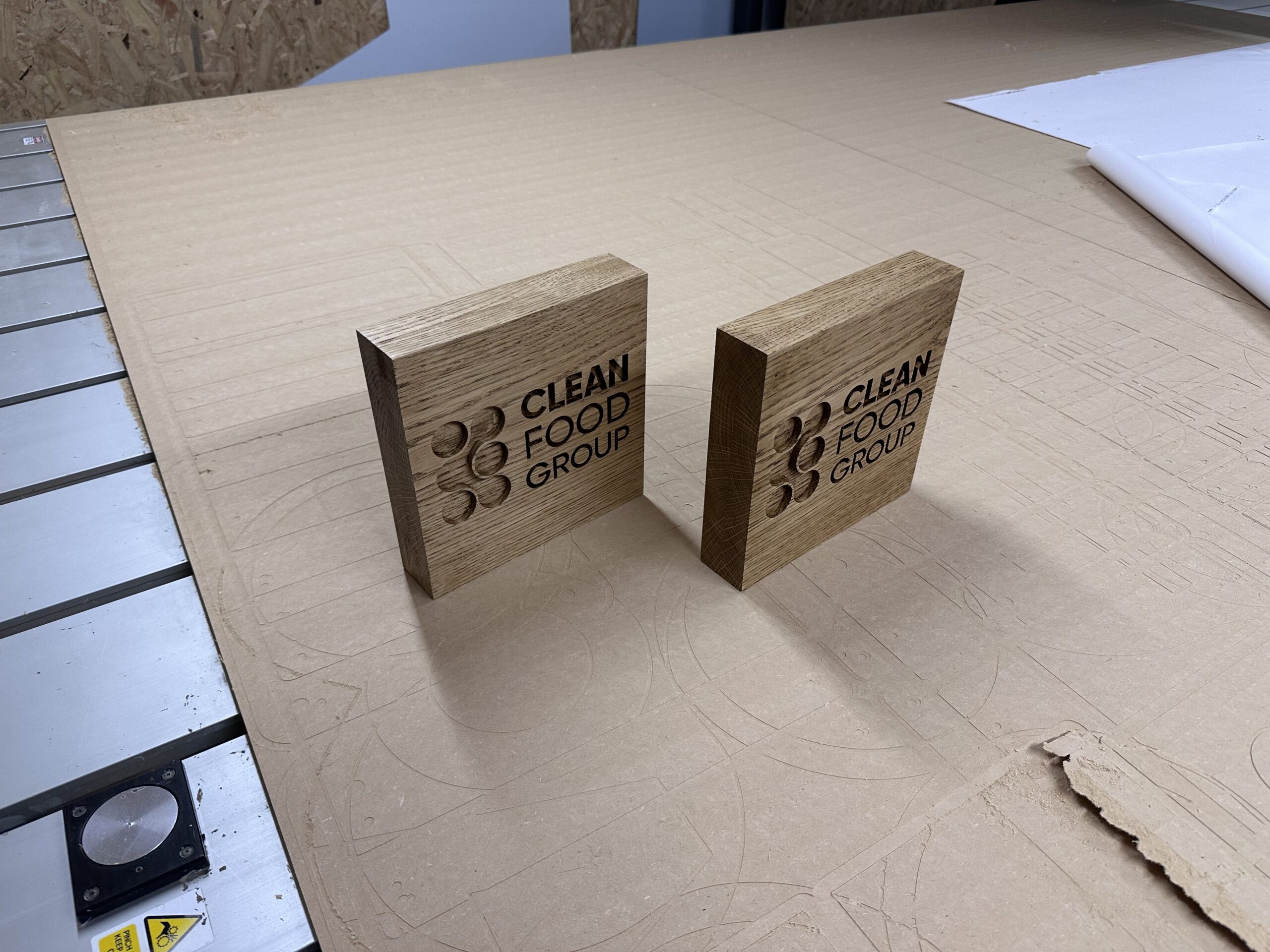 Angled view of two waxed oak desktop blocks showing their thickness and engraved faces